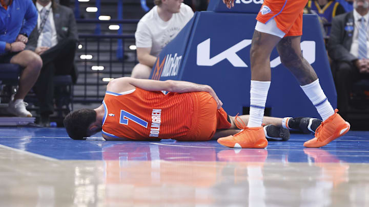 Nov 10, 2024; Oklahoma City, Oklahoma, USA; Oklahoma City Thunder forward Chet Holmgren (7) holds his leg after a hard following a play against the Golden State Warriors during the first quarter at Paycom Center. Mandatory Credit: Alonzo Adams-Imagn Images