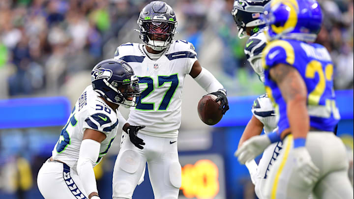 Dec 4, 2022; Inglewood, California, USA; Seattle Seahawks cornerback Tariq Woolen (27) celebrates after intercepting a pass intended for Los Angeles Rams running back Kyren Williams (23) during the first half at SoFi Stadium. Mandatory Credit: Gary A. Vasquez-Imagn Images