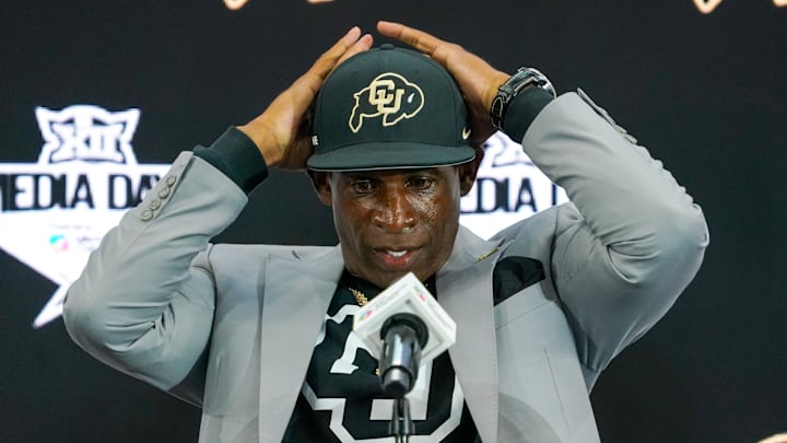Jul 9, 2025; Frisco, TX, USA; Colorado head coach Deion Sanders fixes his cap prior to speaking with the media during 2025 Big 12 Football Media Days at The Star. Mandatory Credit: Raymond Carlin III-Imagn Images Jul 9, 2025; Frisco, TX, USA; Colorado head coach Deion Sanders fixes his cap prior to speaking with the media during 2025 Big 12 Football Media Days at The Star. Mandatory Credit: Raymond Carlin III-Imagn Images