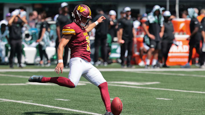 Aug 10, 2024; East Rutherford, New Jersey, USA; Washington Commanders place kicker Riley Patterson (15) kicks off during the fourth quarter against the New York Jets at MetLife Stadium. 