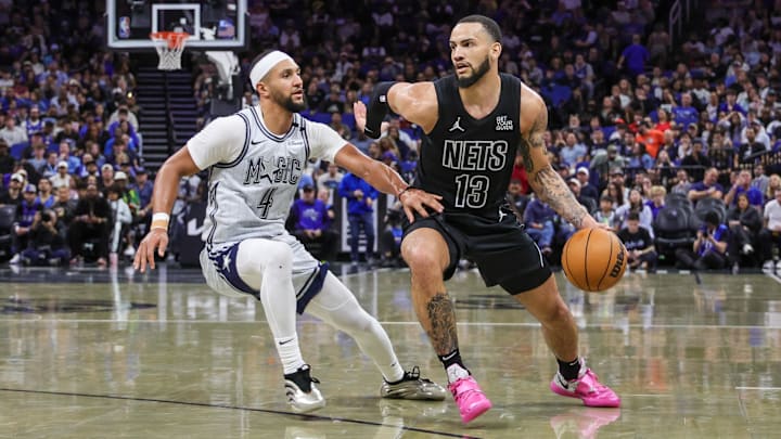 Brooklyn Nets guard Tyrese Martin (13) moves the ball around Orlando Magic guard Jalen Suggs (4) during the second quarter at Kia Center.