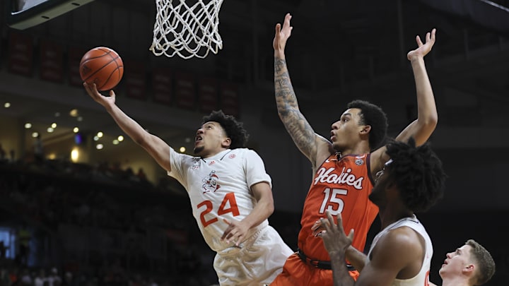 Feb 3, 2024; Coral Gables, Florida, USA; Miami Hurricanes guard Nijel Pack (24) drives to the basket past Virginia Tech Hokies center Lynn Kidd (15) during the second half at Watsco Center. Mandatory Credit: Sam Navarro-Imagn Images
