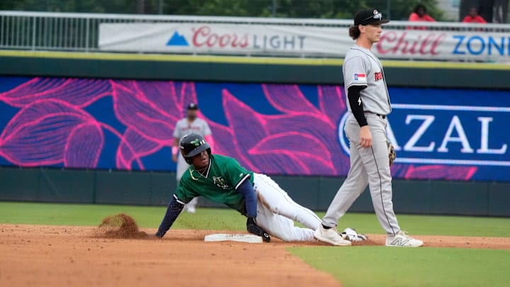 June 4, 2025; North Augusta, South Carolina, USA; Augusta GreenJacket infielder John Gil (7) slides into second base during the second game of the Augusta GreenJacket and Fayetteville series at SRP Park. Mandatory Credit: Katie Goodale - Augusta Chronicle/USA TODAY NETWORK