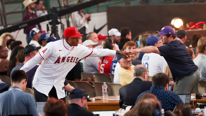 Jul 14, 2024; Ft. Worth, TX, USA;  Christian Moore celebrates with fans after being selected by the Los Angeles Angels as the eight player taken during the first round of the MLB Draft at Cowtown Coliseum. Mandatory Credit: Kevin Jairaj-Imagn Images