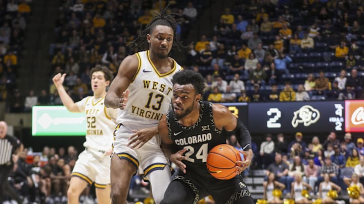 Jan 17, 2026; Morgantown, West Virginia, USA; Colorado Buffaloes guard Barrington Hargress (24) drives down the lane against West Virginia Mountaineers guard Chance Moore (13) during the first half at Hope Coliseum. Mandatory Credit: Ben Queen-Imagn Images