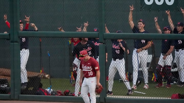 May 15, 2026; Tuscaloosa, AL, USA; The Ole Miss bullpen reacts behind Alabama's Brady Neal (10) to a three-run homer by Will Furniss in the final week of the regular season at Sewell-Thomas Stadium.