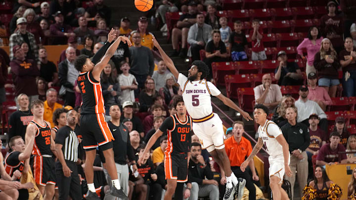 ASU Sun Devils guard Moe Odum (5) defends a shot by Oregon State Beavers guard Josiah Lake II (2) at Desert Financial Arena in Tempe on Dec. 21, 2025. ASU Sun Devils guard Moe Odum (5) defends a shot by Oregon State Beavers guard Josiah Lake II (2) at Desert Financial Arena in Tempe on Dec. 21, 2025.