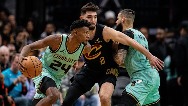 Dec 7, 2024; Charlotte, North Carolina, USA; Charlotte Hornets forward Brandon Miller (24) drives Cleveland Cavaliers guard Ty Jerome (2) into a screen during the third quarter at Spectrum Center. Mandatory Credit: Scott Kinser-Imagn Images