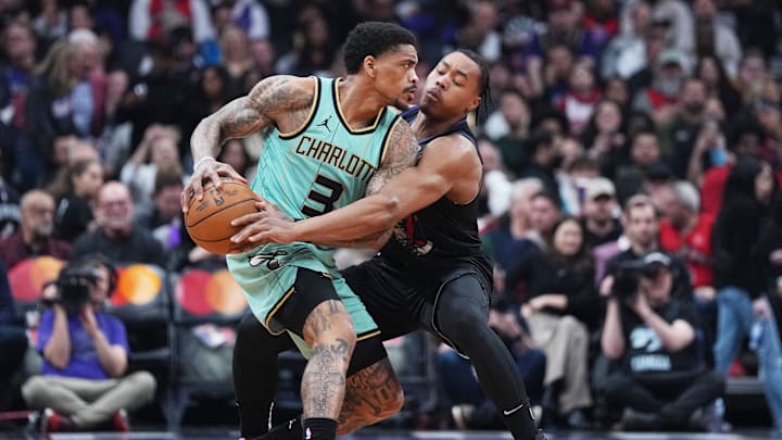 Apr 9, 2025; Toronto, Ontario, CAN; Toronto Raptors forward Scottie Barnes (4) battles for the ball with Charlotte Hornets guard DaQuan Jeffries (3) during the first quarter at Scotiabank Arena. Mandatory Credit: Nick Turchiaro-Imagn Images