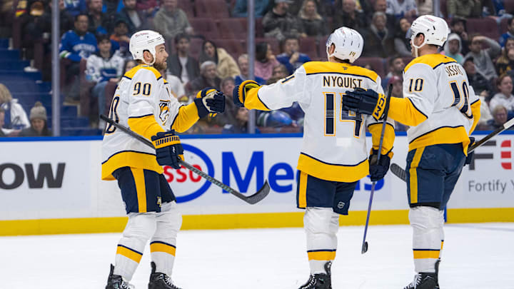 Jan 3, 2025; Vancouver, British Columbia, CAN; Nashville Predators forward Ryan O'Reilly (90), forward Gustav Nyquist (14) and forward Colton Sissons (10) celebrate Nyquist’s goal against the Vancouver Canucks in the third period at Rogers Arena. Mandatory Credit: Bob Frid-Imagn Images
