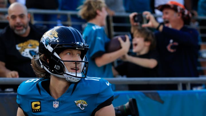 Jacksonville Jaguars quarterback Trevor Lawrence (16) looks on after scoring a touchdown and giving the ball to a young fan during the first quarter of an NFL football matchup at EverBank Stadium, Sunday, Dec. 14, 2025, in Jacksonville, Fla. [Corey Perrine/Florida Times-Union]