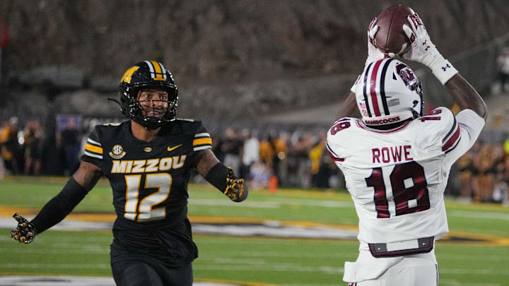 Sep 20, 2025; Columbia, Missouri, USA; South Carolina Gamecocks wide receiver Brian Rowe Jr. (18) catches a pass for a touchdown as Missouri Tigers cornerback Drey Norwood (12) looks on during the first half of the game at Faurot Field at Memorial Stadium. Mandatory Credit: Denny Medley-Imagn Images