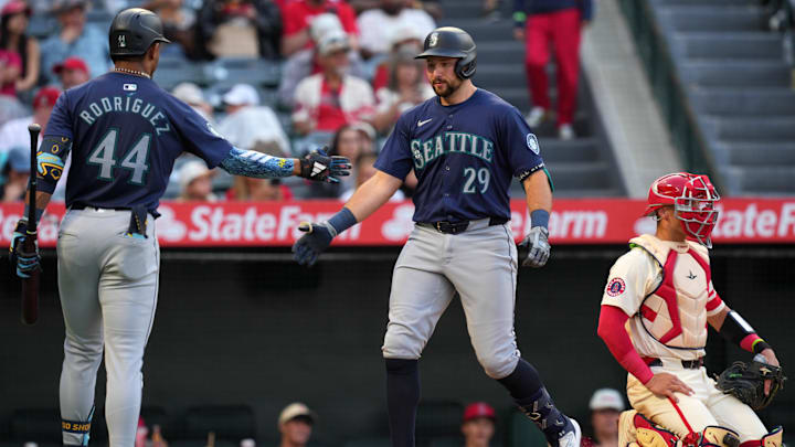Seattle Mariners catcher Cal Raleigh (29) celebrates with center fielder Julio Rodriguez during a game against the Los Angeles Angels on July 12 at Angel Stadium. Seattle Mariners catcher Cal Raleigh (29) celebrates with center fielder Julio Rodriguez during a game against the Los Angeles Angels on July 12 at Angel Stadium.