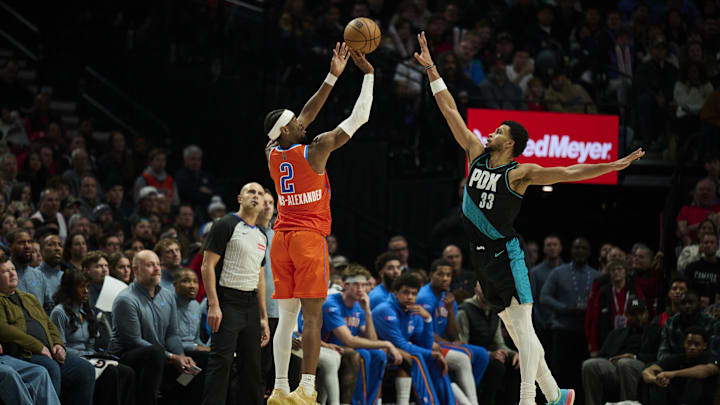 Nov 30, 2025; Portland, Oregon, USA; Oklahoma City Thunder guard Shai Gilgeous-Alexander (2) shoots a three point jump shot during the second half against Portland Trail Blazers forward Toumani Camara (33) at Moda Center. Mandatory Credit: Troy Wayrynen-Imagn Images