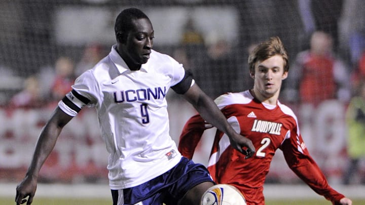 October 1, 2011; Louisville, KY, USA;  Connecticut Huskies forward Stephane Diop (9) moves the ball against Louisville Cardinals defender Greg Cochrane (2) during second half play at Cardinal Park.  Connecticut defeated Louisville 1-0.  Mandatory Credit: Jamie Rhodes-Imagn Images