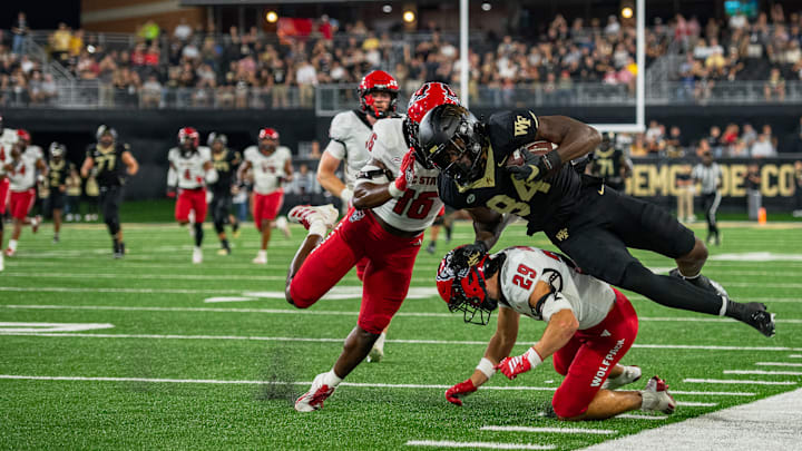 Eni Falayi (84) being forced out of bounds by the NC State Wolfpack, Sept. 11, 2025.