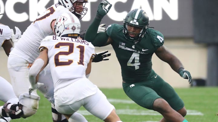 Michigan State Spartans' Jacoby Windmon pursues Minnesota Golden Gophers' Bryce Williams (21) during