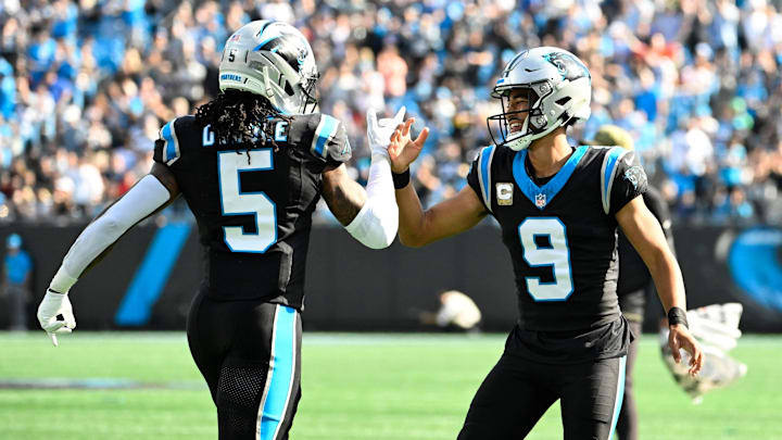Nov 9, 2025; Charlotte, North Carolina, USA; Carolina Panthers running back Rico Dowdle (5) celebrates with quarterback Bryce Young (9) after scoring a touchdown in the first quarter at Bank of America Stadium. 