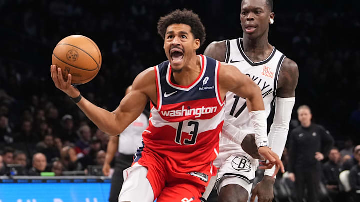 Oct 14, 2024; Brooklyn, New York, USA; Washington Wizards shooting guard Jordan Poole (13) drives to the basket against Brooklyn Nets point guard Dennis Schroder (17) during the second half at Barclays Center.