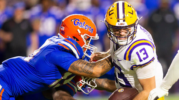 Florida Gators edge T.J. Searcy (19) and Florida Gators edge George Gumbs Jr. (34) sacks LSU Tigers quarterback Garrett Nussmeier (13) causing a fumble during the second half at Ben Hill Griffin Stadium in Gainesville, FL on Saturday, November 16, 2024. The Gators defeated the Tigers 27-16. [Doug Engle/Gainesville Sun]
