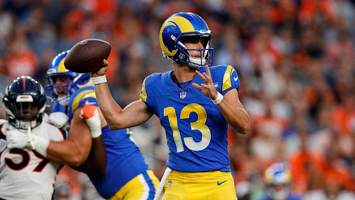 Aug 26, 2023; Denver, Colorado, USA; Los Angeles Rams quarterback Stetson Bennett (13) looks to pass.