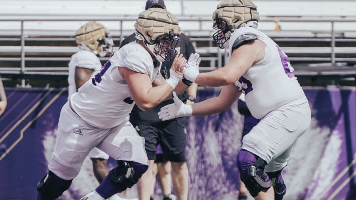 Walk-ons Parker Cross (54) and Roice Cleeland (63) tangle during a spring practice drill. Walk-ons Parker Cross (54) and Roice Cleeland (63) tangle during a spring practice drill.