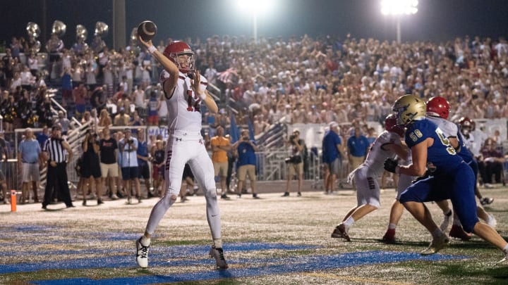 Brentwood Academy's George MacIntyre (12) throws out of his own end zone while being pursued by