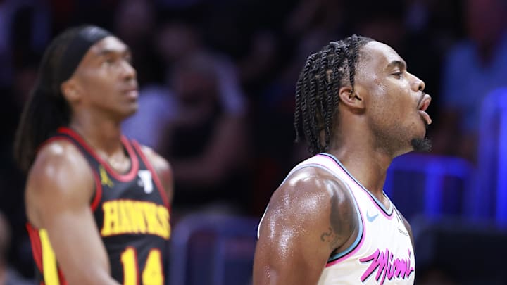 Mar 27, 2025; Miami, Florida, USA;  Miami Heat guard Davion Mitchell (45) reacts in front of Atlanta Hawks guard Terance Mann (14) during the second half at Kaseya Center. Mandatory Credit: Rhona Wise-Imagn Images