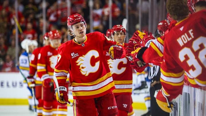 Mar 18, 2026; Calgary, Alberta, CAN; Calgary Flames center Connor Zary (47) celebrates his goal with teammates against the St. Louis Blues during the first period at Scotiabank Saddledome. Mandatory Credit: Sergei Belski-Imagn Images