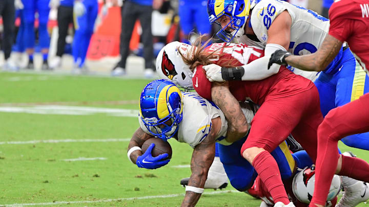 Sep 15, 2024; Glendale, Arizona, USA;  Arizona Cardinals linebacker Dennis Gardeck (45) tackles Los Angeles Rams running back Kyren Williams (23) in the first half at State Farm Stadium. Mandatory Credit: Matt Kartozian-Imagn Images