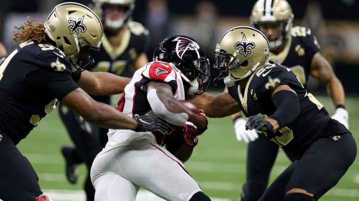 New Orleans Saints defenders Cameron Jordan and Marshon Lattimore make a tackle against the Atlanta Falcons 