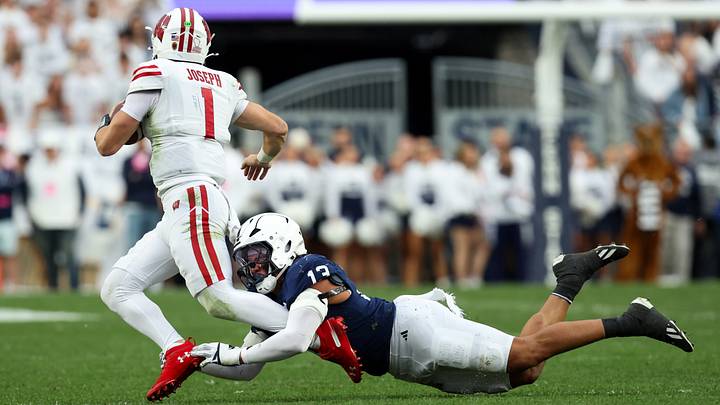 Penn State Nittany Lions linebacker Tony Rojas (13) attempts to tackle Wisconsin Badgers quarterback Colton Joseph (1)