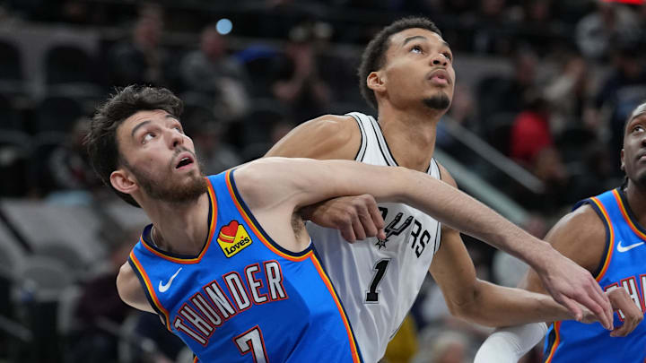 Feb 29, 2024; San Antonio, Texas, USA; Oklahoma City Thunder forward Chet Holmgren (7) and San Antonio Spurs center Victor Wembanyama (1) battle for position in the first half at Frost Bank Center.
