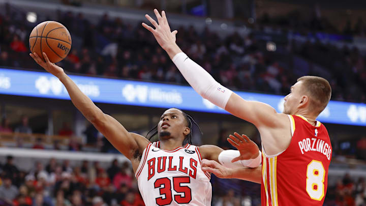 Oct 27, 2025; Chicago, Illinois, USA; Chicago Bulls forward Isaac Okoro (35) goes to the the basket against Atlanta Hawks center Kristaps Porzingis (8) during the first half at United Center. Mandatory Credit: Kamil Krzaczynski-Imagn Images Oct 27, 2025; Chicago, Illinois, USA; Chicago Bulls forward Isaac Okoro (35) goes to the the basket against Atlanta Hawks center Kristaps Porzingis (8) during the first half at United Center. Mandatory Credit: Kamil Krzaczynski-Imagn Images