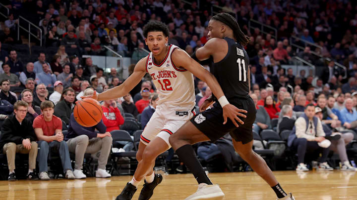 Mar 13, 2025; New York, NY, USA; St. John's basketball guard RJ Luis Jr. (12) drives to the basket against Butler Bulldogs forward Jahmyl Telfort (11) during the second half at Madison Square Garden.