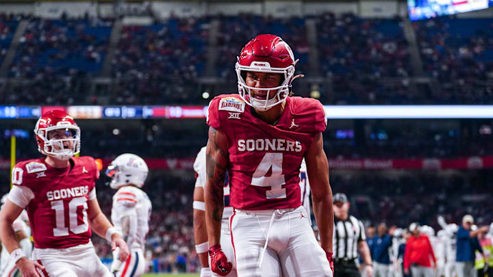 Dec 28, 2023; San Antonio, TX, USA;  Oklahoma Sooners wide receiver Nic Anderson (4) celebrates a touchdown catch in the first half against the Arizona Wildcats at Alamodome. Mandatory Credit: Daniel Dunn-Imagn Images