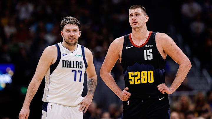 Dallas Mavericks guard Luka Doncic (77) and Denver Nuggets center Nikola Jokic (15) in the second quarter at Ball Arena. Mandatory Credit: Isaiah J. Downing-Imagn Images