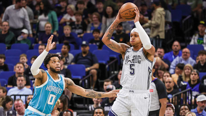 Orlando Magic forward Paolo Banchero (5) passes the ball in front of Charlotte Hornets forward Miles Bridges (0) during the first quarter at Kia Center. 
