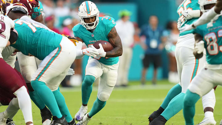 Aug 17, 2024; Miami Gardens, Florida, USA;  Miami Dolphins running back Raheem Mostert (31) runs for a first down against the Washington Commanders during the first quarter at Hard Rock Stadium. Mandatory Credit: Jim Rassol-Imagn Images