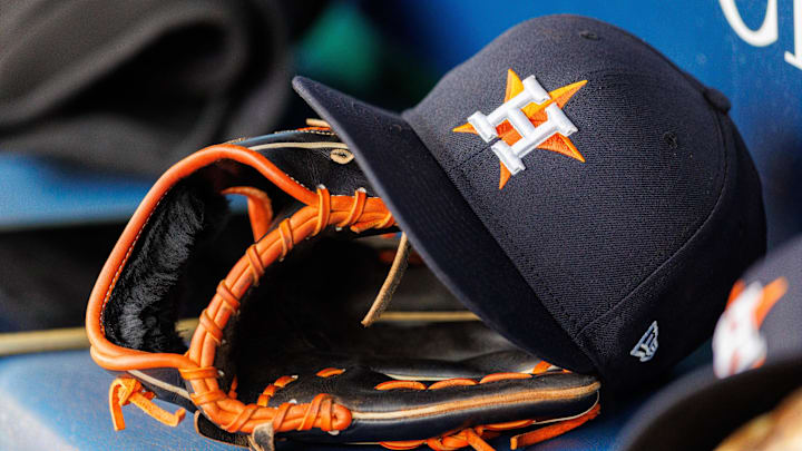 Apr 27, 2025; Kansas City, Missouri, USA; Houston Astros hat and glove in the dugout during the second inning against the Kansas City Royals at Kauffman Stadium. Mandatory Credit: William Purnell-Imagn Images