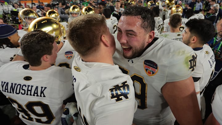 Jan 9, 2025; Miami, FL, USA; Notre Dame Fighting Irish offensive lineman Tosh Baker (79) celebrates with offensive lineman Sam Pendleton (72) after defeating the Penn State Nittany Lions  in the Orange Bowl at Hard Rock Stadium. Mandatory Credit: Sam Navarro-Imagn Images