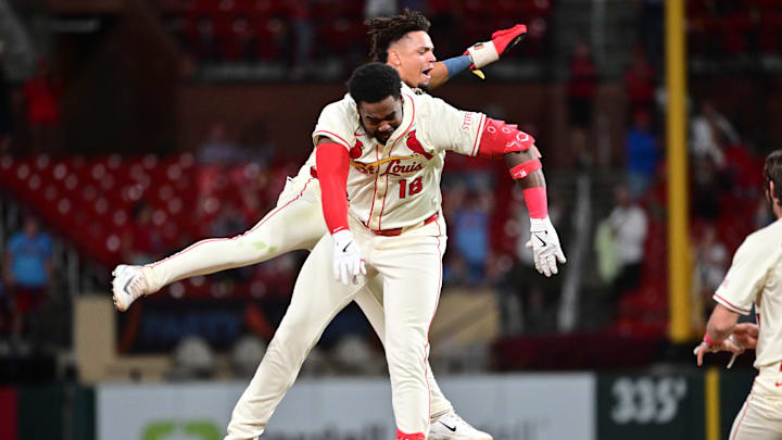 Sep 6, 2025; St. Louis, Missouri, USA;  St. Louis Cardinals outfielder Jordan Walker (18, front) and St. Louis Cardinals shortstop Masyn Winn (0) leap in the air to celebrate their 3-2 win over the San Francisco Giants after Walker doubled to left, scoring Winn and teammate St. Louis Cardinals second baseman Garrett Hampson (not shown) in the bottom of the ninth inning at Busch Stadium. Mandatory Credit: Tim Vizer-Imagn Images