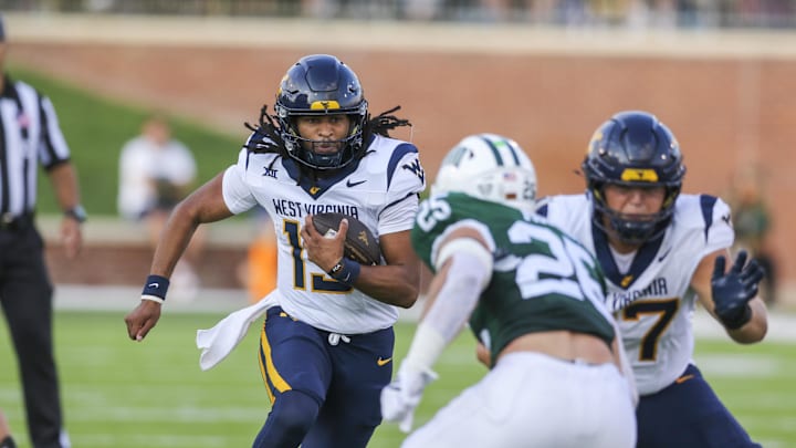 Sep 6, 2025; Athens, Ohio, USA; West Virginia Mountaineers quarterback Jaylen Henderson (13) runs the ball during the fourth quarter against the Ohio Bobcats at Peden Stadium. Mandatory Credit: Ben Queen-Imagn Images