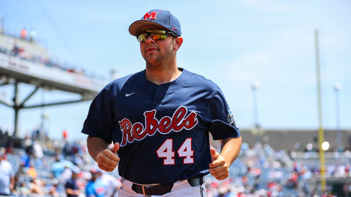 Jun 26, 2022; Omaha, NE, USA; Ole Miss pitcher Dylan DeLucia (44) runs back to the dugout just before the first inning against the Oklahoma Sooners at Charles Schwab Field. Mandatory Credit: Jaylynn Nash-USA TODAY Sports