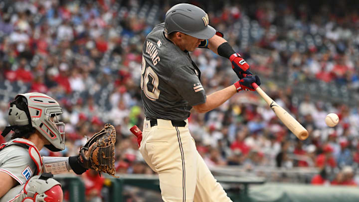 Sep 29, 2024; Washington, District of Columbia, USA; Washington Nationals center fielder Jacob Young (30) hits the ball into play against the Philadelphia Phillies during the fifth inning at Nationals Park