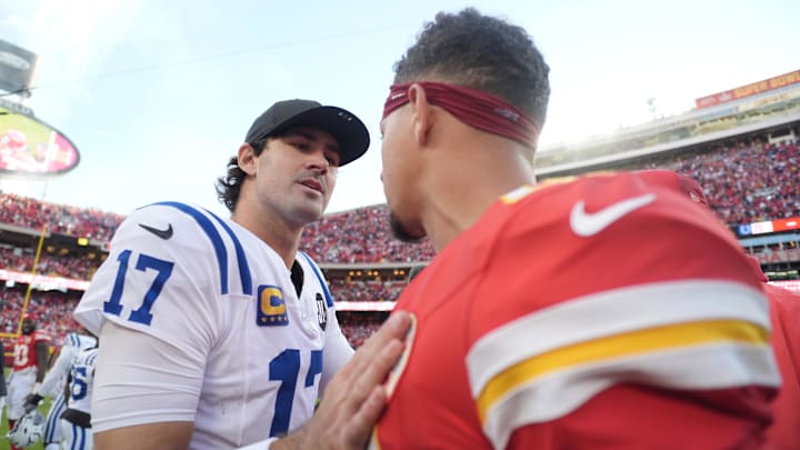 Indianapolis Colts quarterback Daniel Jones (17) and Kansas City Chiefs quarterback Patrick Mahomes (15) meet on field after the game at GEHA Field at Arrowhead Stadium.