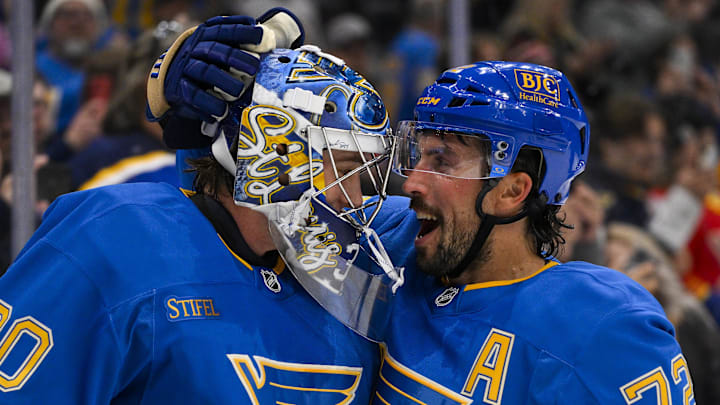 Oct 19, 2024; St. Louis, Missouri, USA;  St. Louis Blues defenseman Justin Faulk (72) and goaltender Joel Hofer (30) celebrate after the Blues defeated the Carolina Hurricanes at Enterprise Center. Mandatory Credit: Jeff Curry-Imagn Images