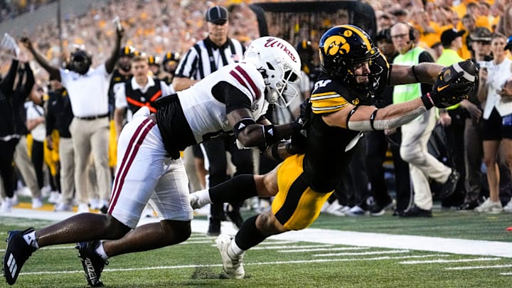 DUPLICATE***Iowa Hawkeyes wide receiver Kaden Wetjen (21) dives into the endzone to score as Massachusetts Minutemen safety DD Snyder (4) defends Sept. 13, 2025 at Kinnick Stadium in Iowa City, Iowa.