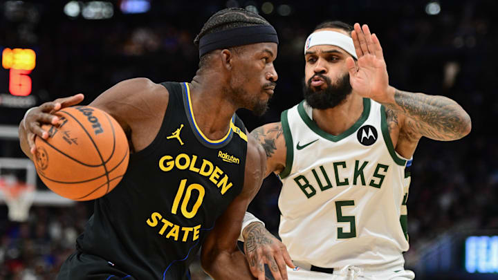 Feb 10, 2025; Milwaukee, Wisconsin, USA;  Golden State Warriors forward Jimmy Butler (10) drives for the basket against Milwaukee Bucks guard Gary Trent Jr. (5) in the first quarter at Fiserv Forum. Mandatory Credit: Benny Sieu-Imagn Images