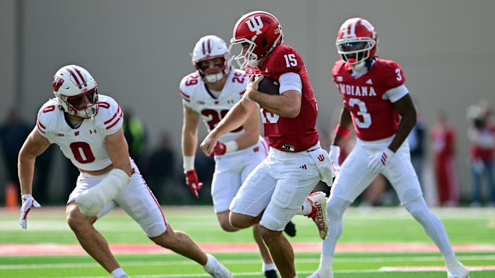 Nov 15, 2025; Bloomington, Indiana, USA;  Indiana Hoosiers quarterback Fernando Mendoza (15) runs the ball toward Wisconsin Badgers linebacker Christian Alliegro (0) during the second quarter at Memorial Stadium. Mandatory Credit: Marc Lebryk-Imagn Images